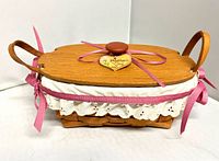 Complete basket with lid, ribbon, handles visible