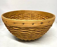 Side view showing woven construction and rim nails