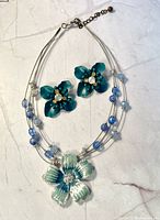 Front view of necklace and both earrings displayed