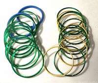 Mixed plastic and metal bangles grouped on white background
