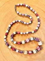 Necklace coiled to show cube beads and spacers