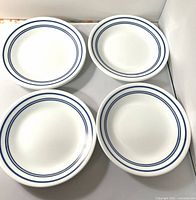 Front view of four plates showing blue rim design