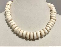Close-up of front portion showing white magnesite donut beads