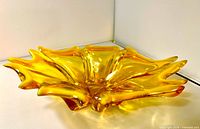 Side profile of yellow multi-tipped art glass bowl showing freeform shape