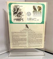 Front view showing information sheet and first day cover with owl stamps in acrylic stand