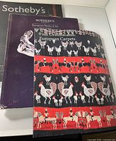 Three Sothebys catalogs stacked showing covers
