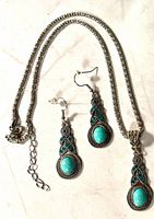 Necklace and earrings laid out to show design and stones