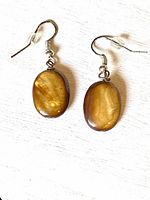 pair of tiger’s eye drop earrings front view on white backdrop