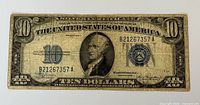 Obverse of the Series 1934-A $10 Silver Certificate showing portrait, serial B21267357A, blue seal, wear