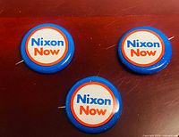 Front view showing three blue "Nixon Now" buttons