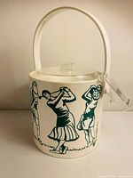 front view of ice bucket showing golfer graphics, handle, lid, tongs
