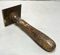 Angled view showing handle and square blade