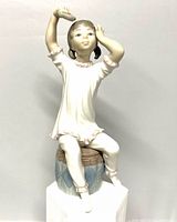 Front view of Lladro Girl Shampooing Hair figurine