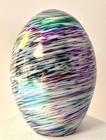 Front view showing iridescent swirl pattern on glass egg