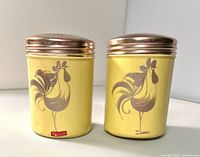 Front view of both yellow rooster shakers
