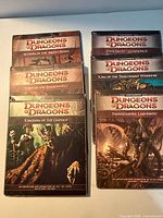 Front covers of all six D&D 4E modules stacked, titles visible