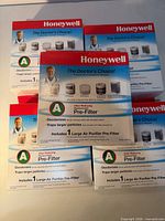 Five front-facing boxes of Honeywell odor-reducing pre-filters