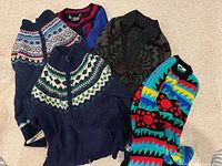 Group shot of all five sweaters and cardigans showing patterns and colors