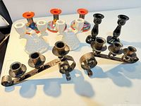 Group shot of all nine candle holders arranged on table