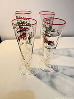 Four champagne flutes grouped to show overall design and condition