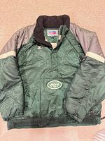 Front view showing color pattern, Jets logo, Starter logo, zipper style, cuffs and hem