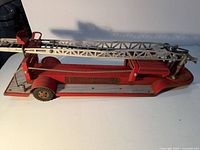 Left side view showing entire fire truck and ladder