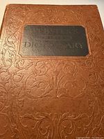 Front cover showing embossed design and black title panel