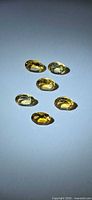 Six oval golden citrines displayed on white background