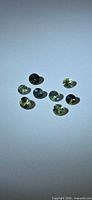 Eight round brilliant-cut multicolored sapphires on neutral background