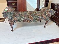 Full view of bench front showing upholstery pattern and cabriole legs