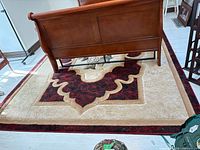 Full view of rectangular area rug under bed frame, showing color and pattern
