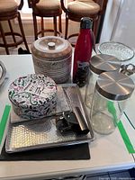 Group shot showing trays, canisters, bottle, tin, cheese boards