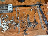 All necklaces laid out with metal jewellery box