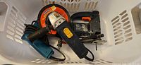 All three power tools placed in laundry basket