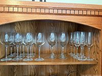 wine glasses and champagne flutes on wooden shelf