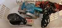 Makita 9924DB belt sander, Ryobi sander, cords and dust bags in view