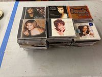Stacks of jewel case CDs featuring Barbra Streisand, Titanic soundtrack, Funk Party and others