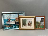Three framed oil paintings side-by-side for size comparison