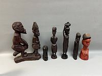 all seven carved figures lined up for size comparison