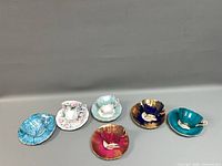 Group shot of six cup and saucer sets