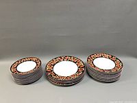 Three stacks of assorted size plates