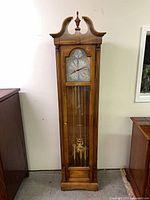 Full front view of wooden grandfather clock