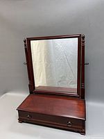 Overall view showing tilting mirror, wooden base with drawer