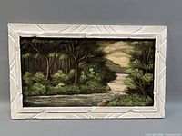 Front view of framed landscape velvet painting
