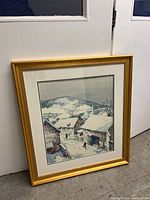 Framed lithograph leaning against door showing full frame