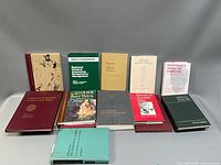 Overall view of 16 medical and related books standing and lying flat