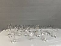 Sixteen platinum-rimmed glasses arranged together