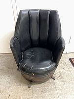 Front view showing black vinyl upholstery and seat damage