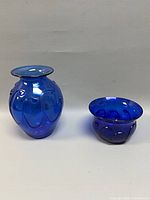 Front view of both cobalt blue vases showing forms and colour