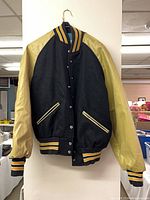 Front view of varsity jacket hanging to show overall style and condition